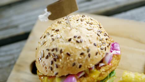 hamburger and french fries on wooden board