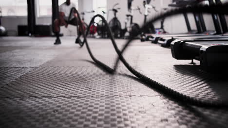 man working out with a jumping rope in a gym