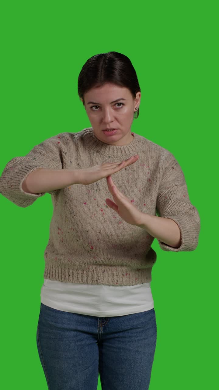 Vertical video: Front view of caucasian woman doing t shape symbol