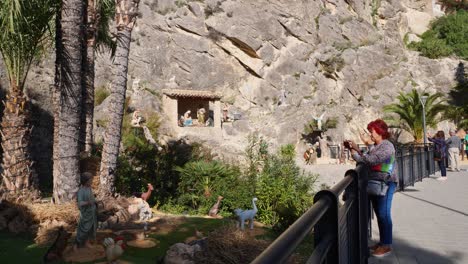 tourists visiting the traditional human sized nativity scene