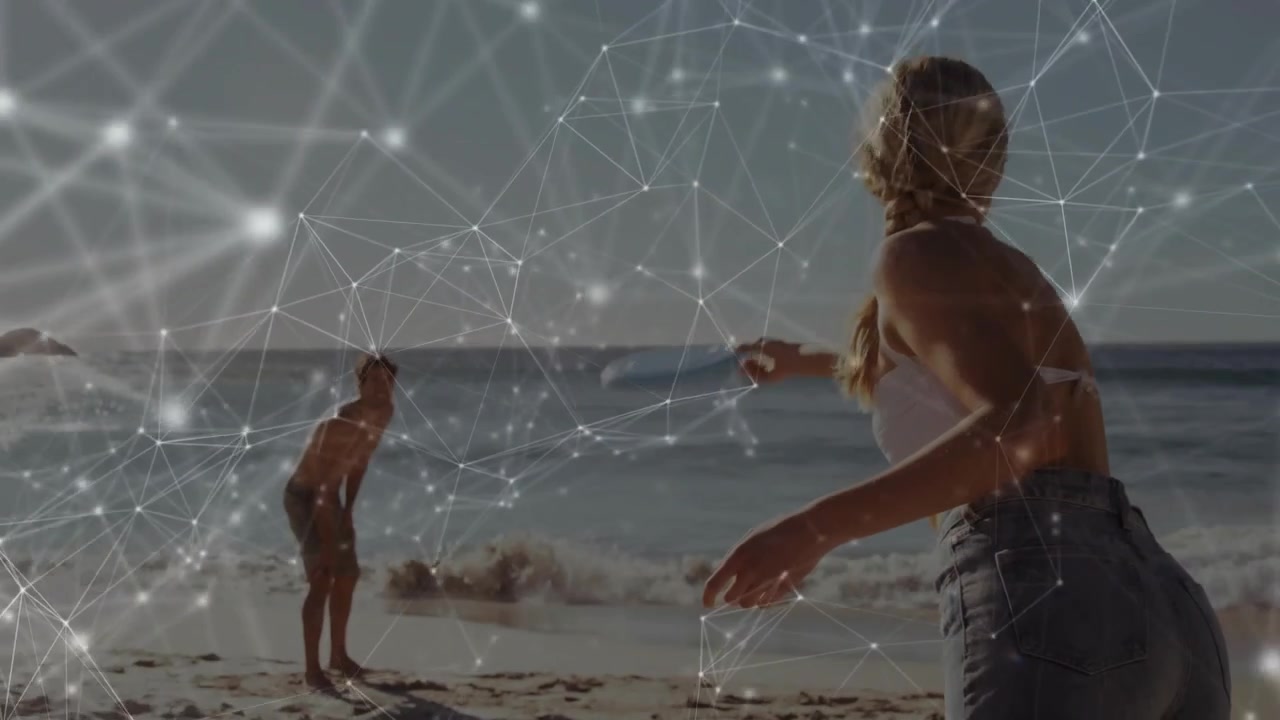 Woman shifting stance and throwing blue disc to partner on beach, tech overlay tracking arc