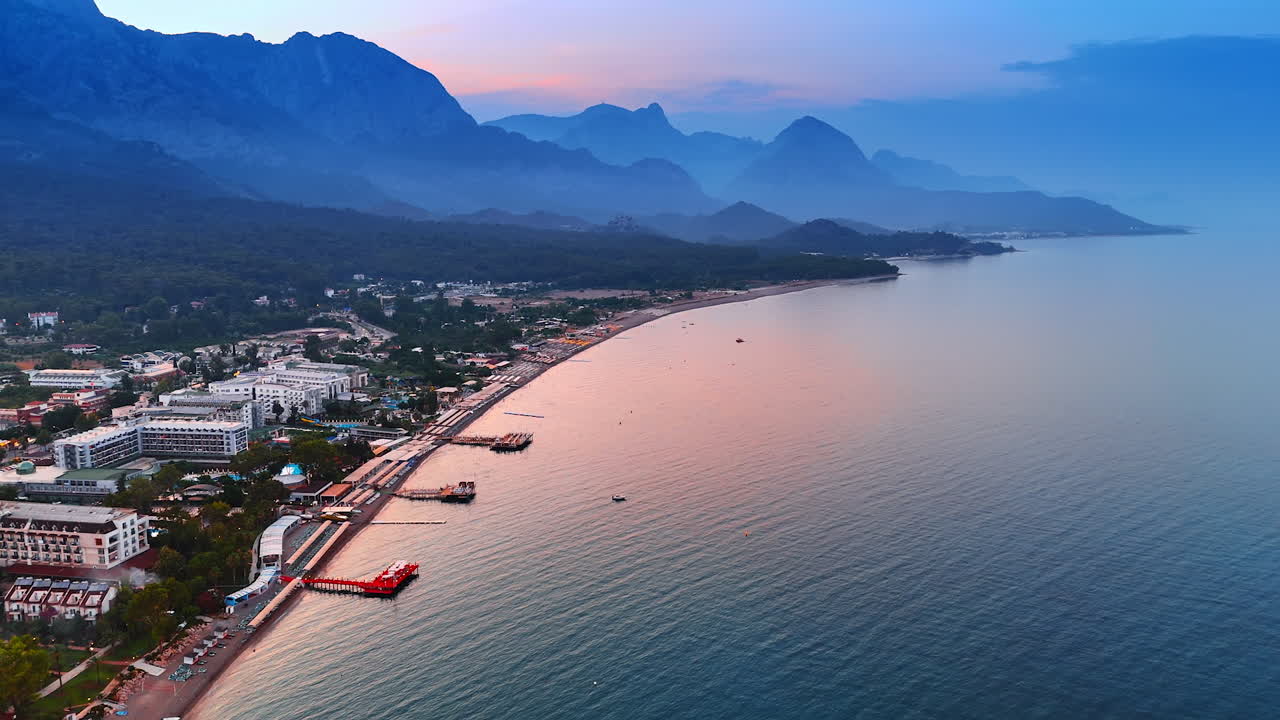 Flying over the beautiful shore of the Mediterranean Sea. Touristic infrastructure of Kemer, Turkey at sunset time