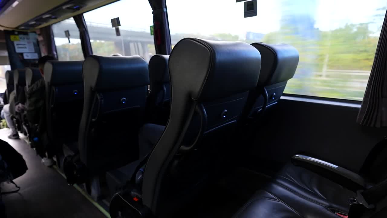 Comfortable coach interior with USB-equipped seats, traveling along a highway