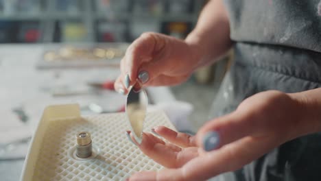 woman crafting glass jewelry