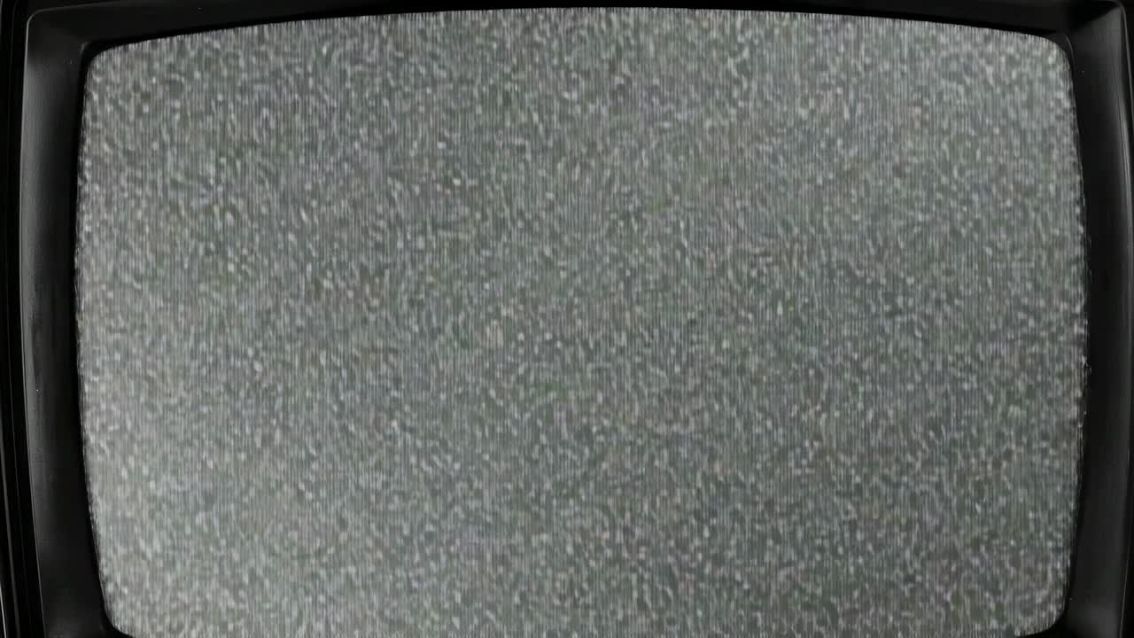 Flickering static speckles covering vintage CRT television screen in dimly lit room, retro theme