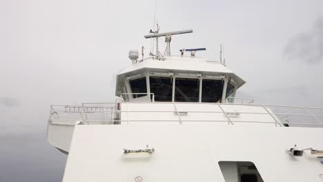 Ship-bridge-with-rotating-marine-radar,-white-vessel