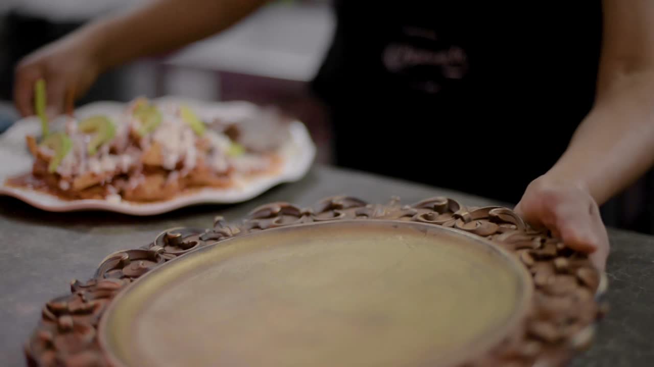 Traditional mexican dish called chilaquiles with salted meat called cecina ready to be served at a local cafe diner restaurant in latin america