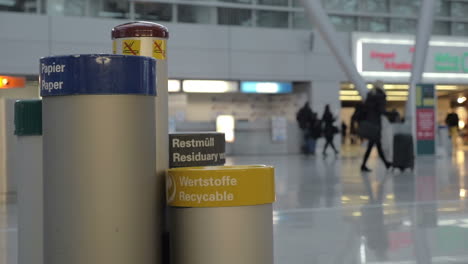 Woman-throwing-out-plastic-bottle-into-recycable-bin