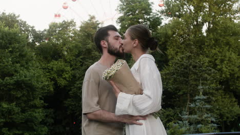 young couple kissing at the park