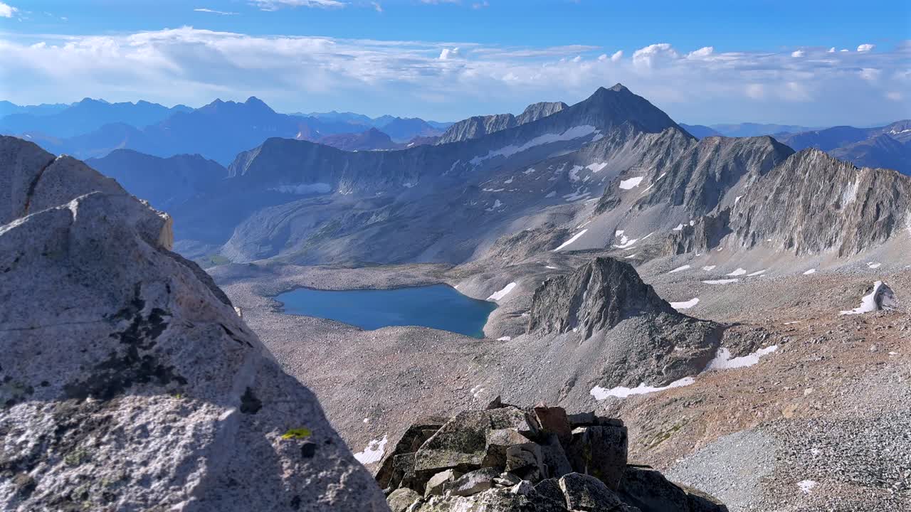 Capitol Peak 14er Wilderness high alpine elevation Rocky Mountains Colorado aerial drone Maroon Bells Peaks Mount Snowmass Knifes Edge Ridge Pierre Lakes summer morning blue sky cloudy right slide