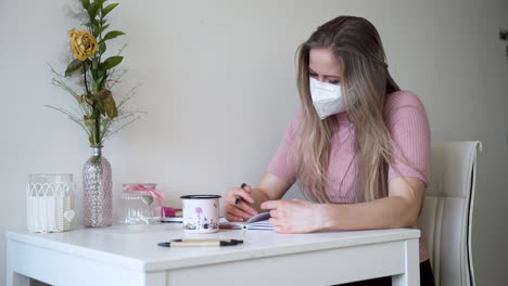 a young girl writes a letter to her lover in her apartment