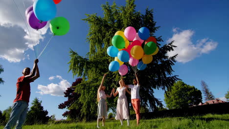 friends with balloons in a park