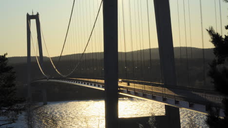 cars driving over a bridge, at a sunny evening, at hoga kusten, vasternorrland, sweden