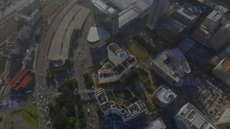 aerial view of cityscape with data processing animation over buildings and roads