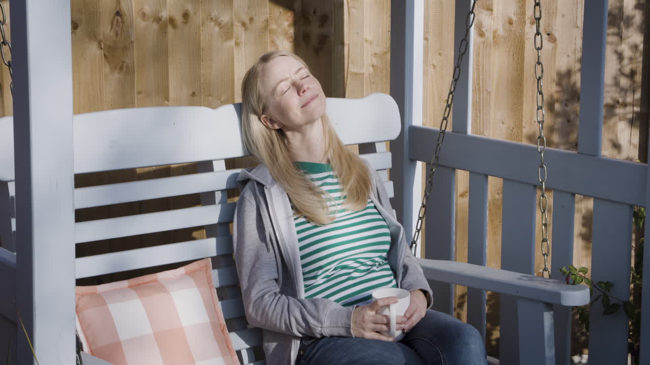 Woman Relaxing on a Porch Swing