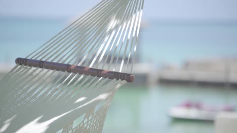 established close up of white hammock with blurred sea ocean beach tropical background relax holiday vacation concept
