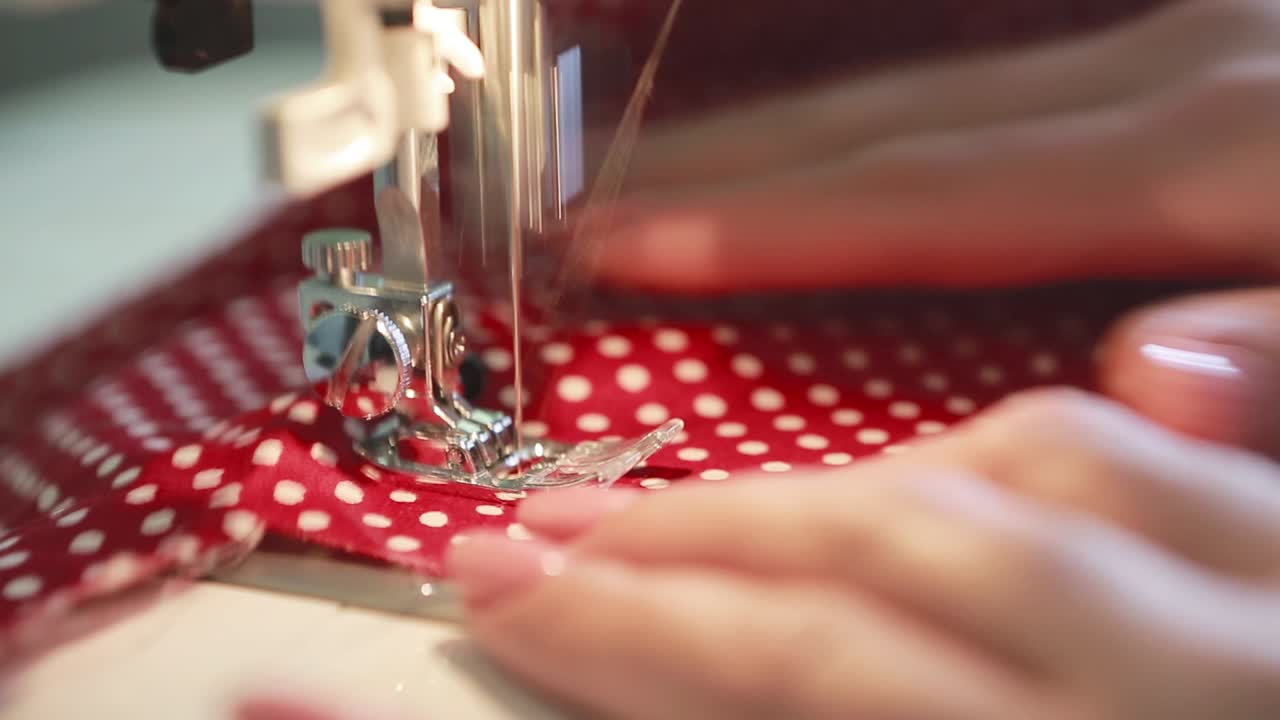 Dressmaker Woman Sews Clothes. Woman sewing at home on sewing machine
