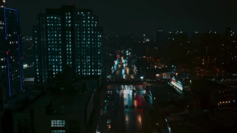 flying over new york city street, cars traffic and buildings, night