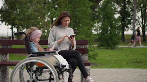 girl watches cartoons while woman checking social media