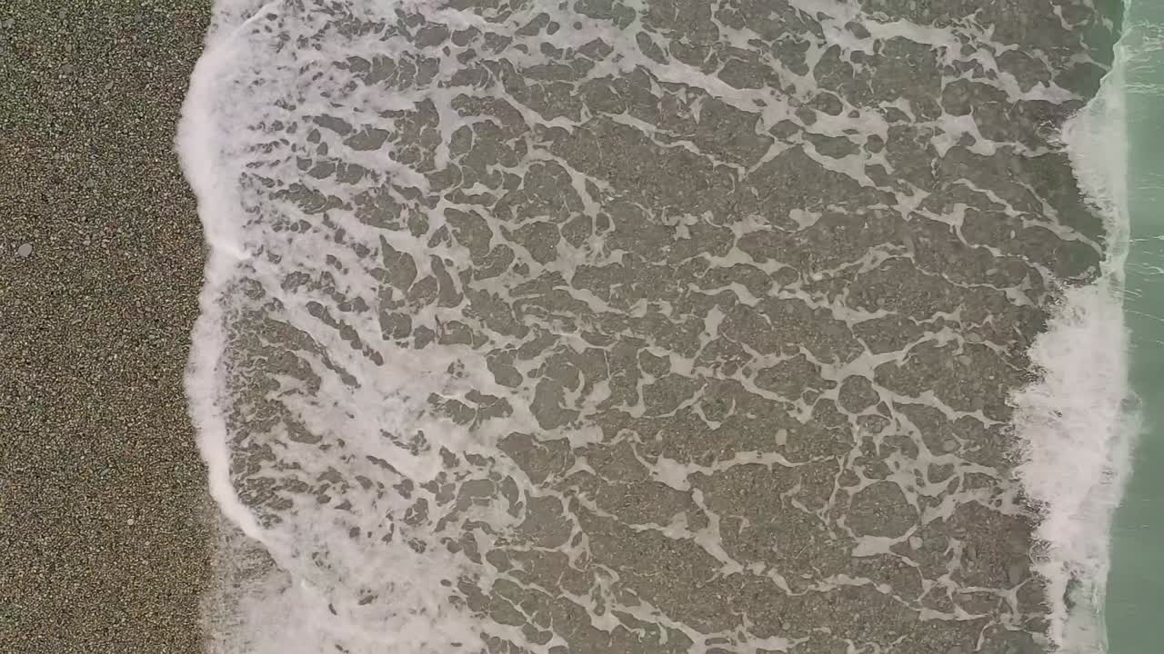 Slow Motion Aerial View of Ocean Waves Along Looc Bay's Coastal Beach with Turquoise Waters, Philippines