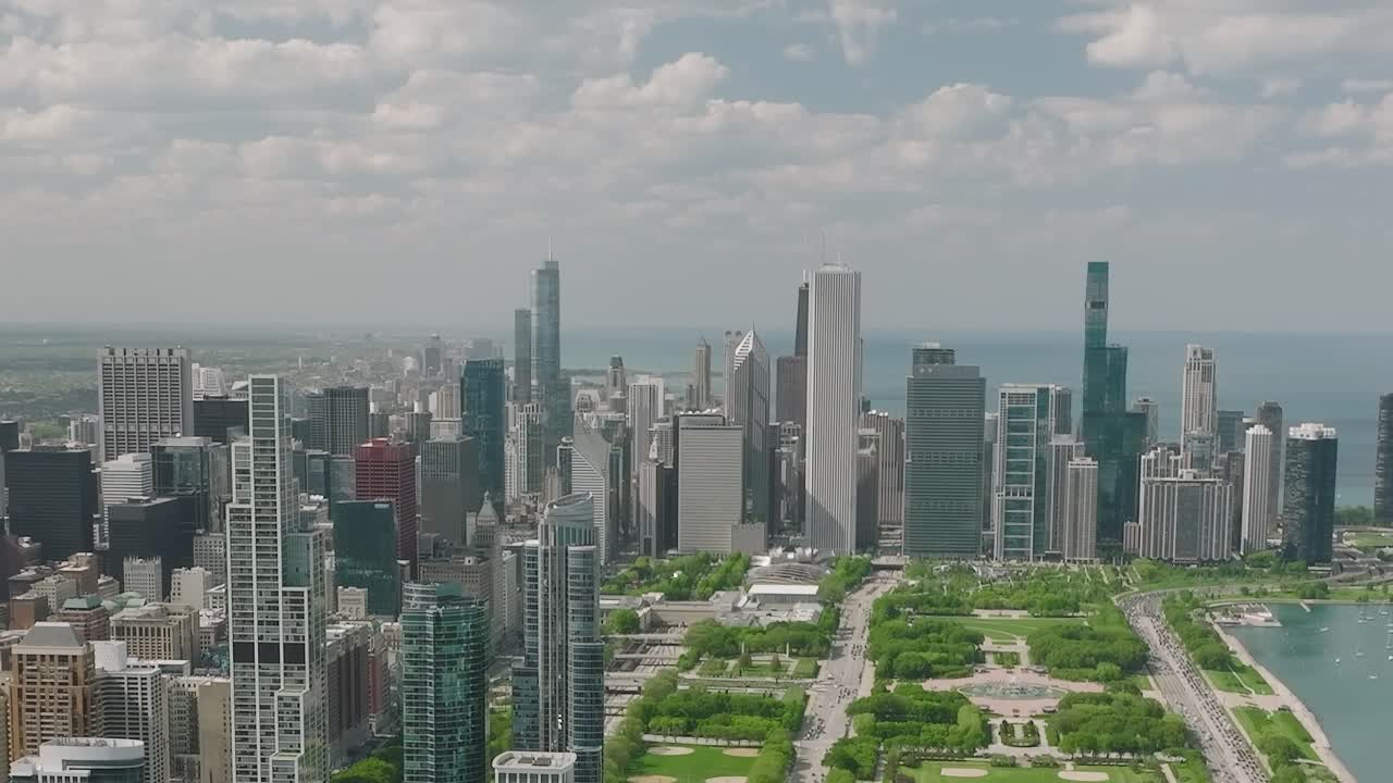 Aerial view of Chicago showing buildings and green spaces under a blue sky