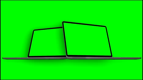 video 4k. dos computadoras portátiles (notebook) encendidas con pantalla verde sobre un fondo verde.