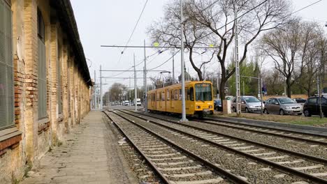 empty yellow electric tram on railroad tracks in budapest hungary