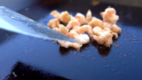 Flipping-shrimp-on-the-grill-close-up