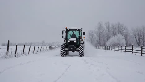 tractor driving on a snowy winter road