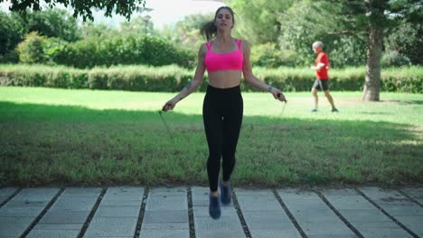 Woman-doing-exercise-with-jumping-rope-in-park