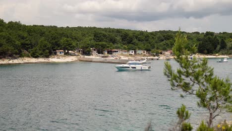 Luxury-speedboat-moored-in-the-blue-water-at-Beach-Njive,-Premantura,-Croatia