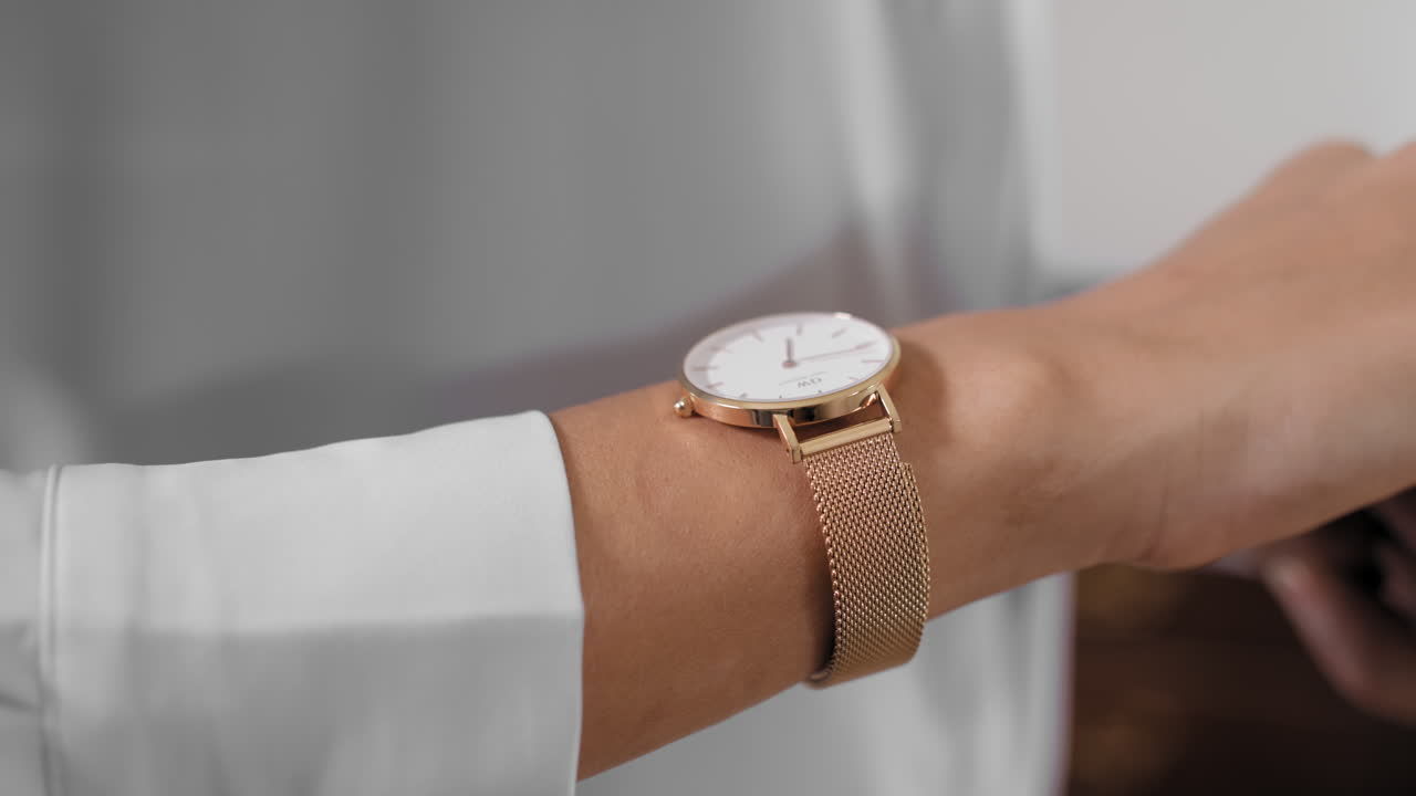 Gold watch in a women wrist. Gold watch in a women wrist, hand, looking at clock, preparing for an event. 4k footage