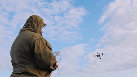 el hombre controla el dron el dron vuela en el cielo