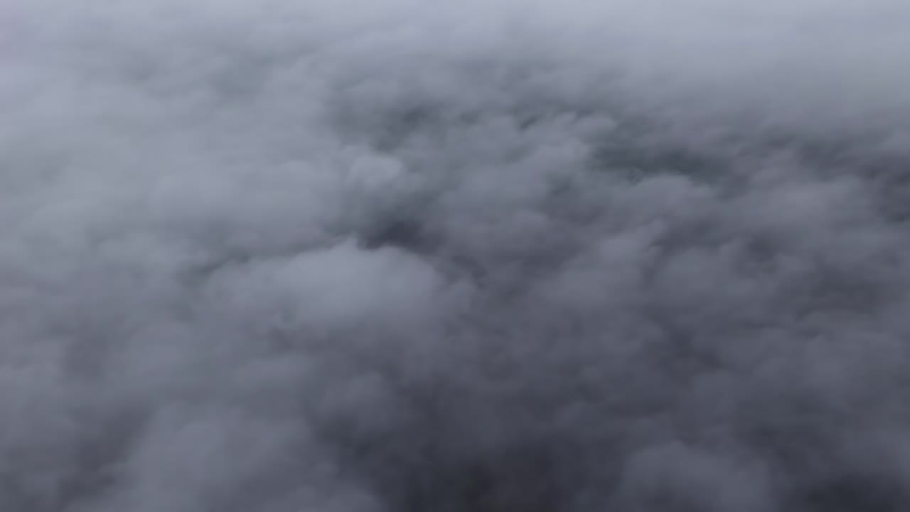 Thick expanse of low-hanging clouds fog, aerial drone view high altitude