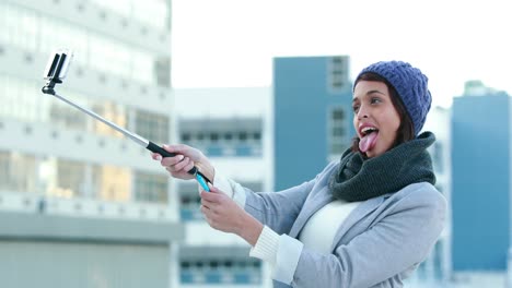 smiling woman using selfie stick
