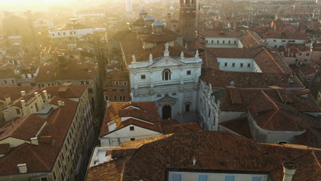 old venetian roofs at sunrise in venice, italy - aerial shot