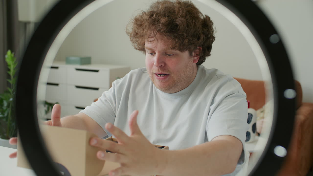 Blogger Unboxing Shirt and Talking to Camera as Filming Clothing Review