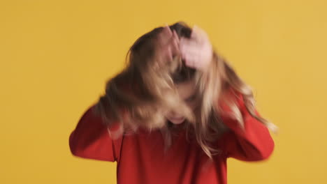 teenage caucasian waving head in front of the camera.