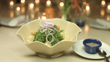 panning shot of a salad in a bowl for a candle light dinner 4k