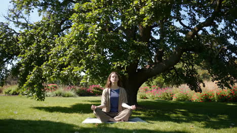 woman meditating in a park