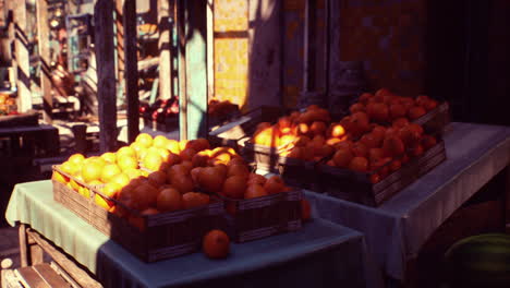 a table full of ripe oranges at a market stall