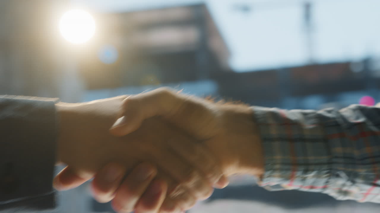 Two people shaking hands, signifying agreement or partnership