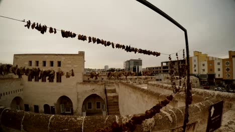 fruits dry on ropes on background old stone town urfa