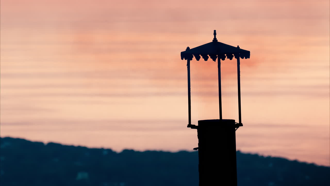 Aerial view a lighthouse with the Eze seaside commune in the Alpes-Maritimes at sunset on the background