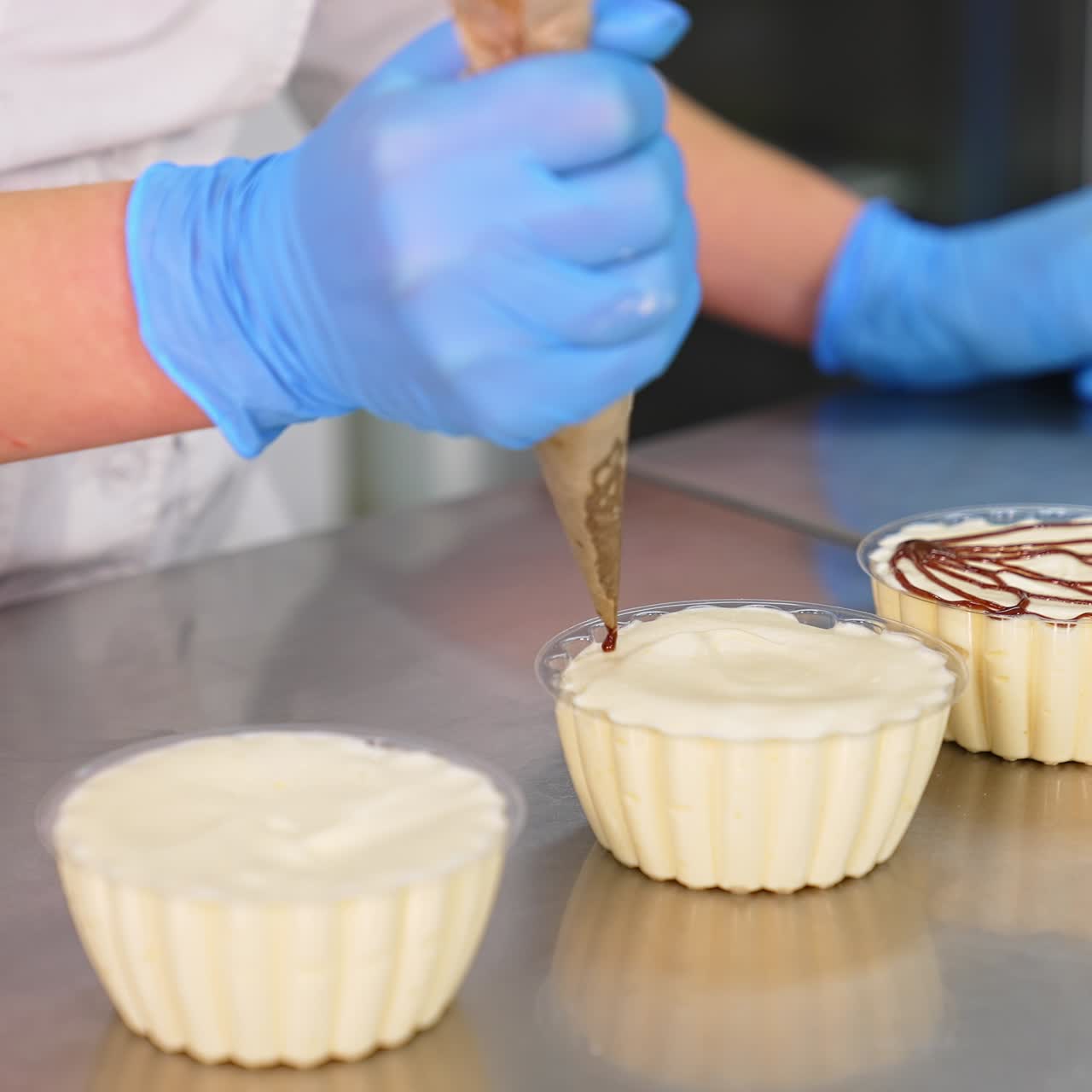 Bakery specialist making sweet deserts. Pastry confectionery cooking