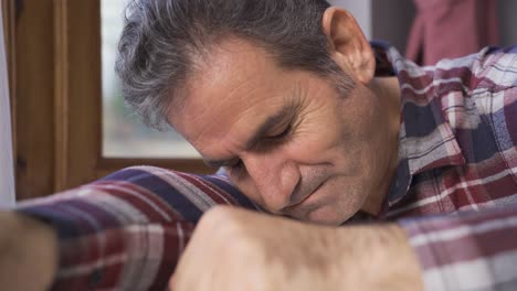 frustrated and depressed mature man clenching his fists.