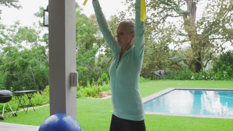 senior woman exercising in a garden