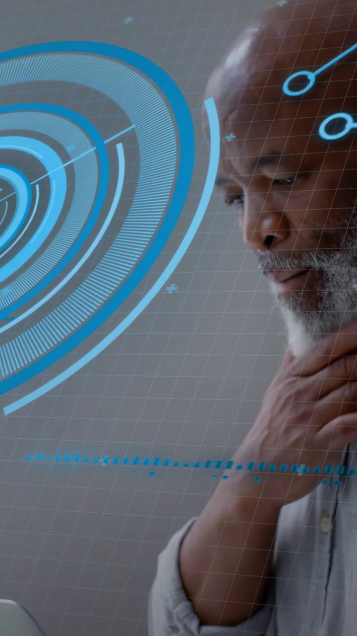 Vertical video: Mature male analyst typing laptop, revealing blue HUD and analyzing dashboard data