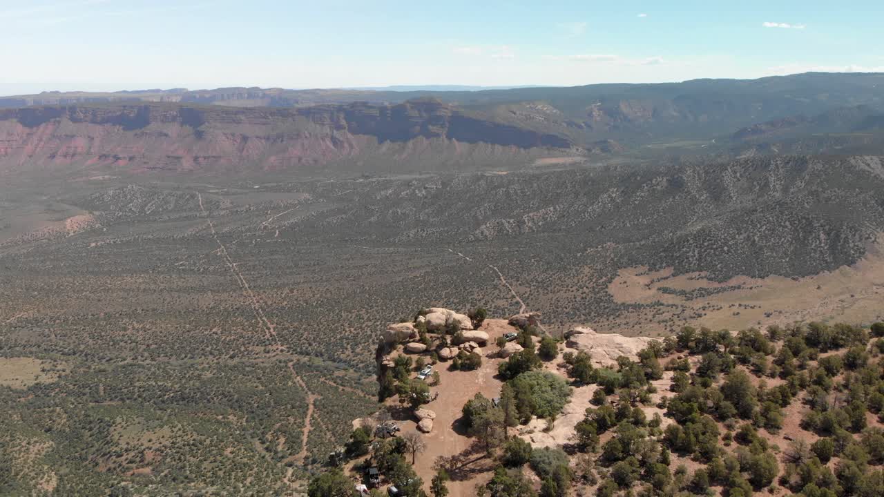 Aerial retreats from canyon rim campsite high above Castle Valley Moab
