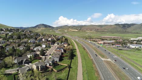 A-reverse-drone-pan-over-I-70-with-cars-traveling-towards-Denver-Colorado